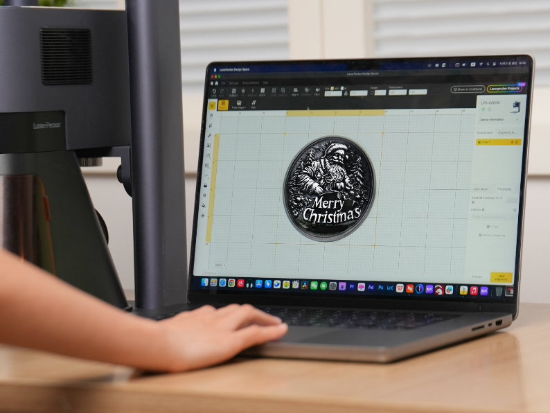 Laptop screen displaying the LaserPecker Design Space software interface, with a "Merry Christmas" coin engraving design in progress – part of LaserPecker LP5's "Design, Preview, and Execute" workflow.