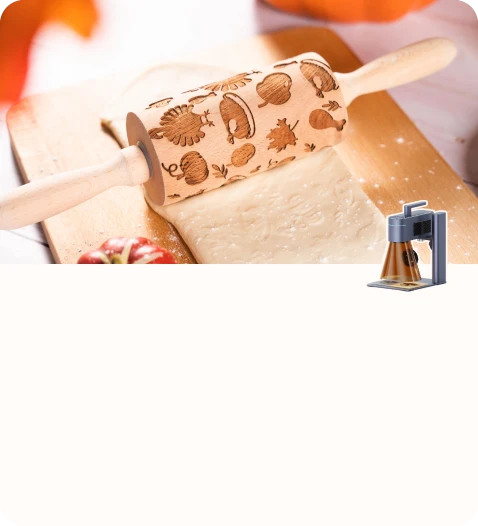A wooden rolling pin decorated with autumn-themed engraved patterns resting on flattened dough.