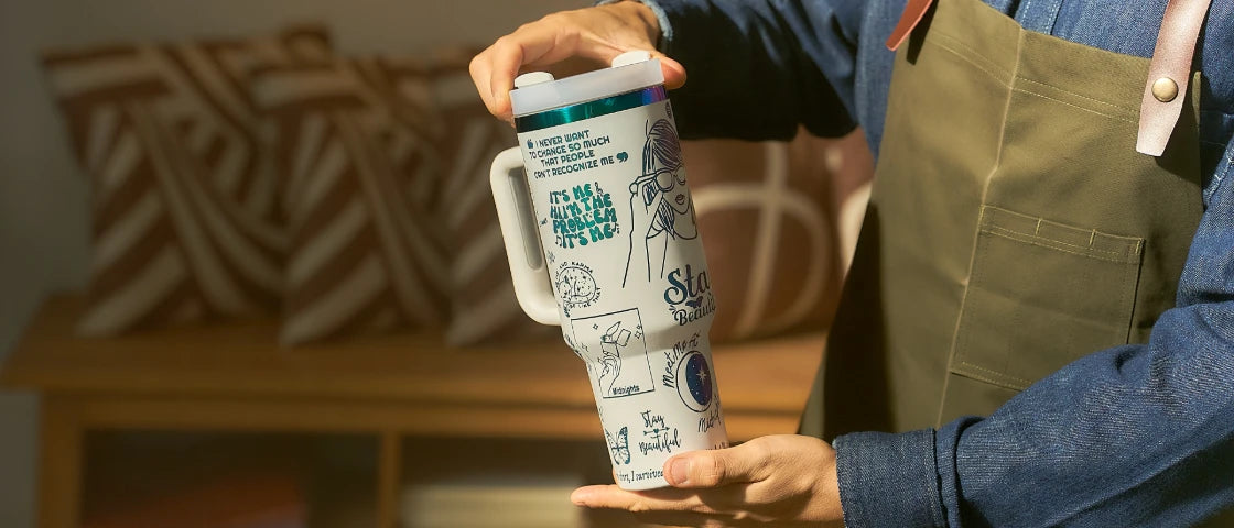 A personalized tumbler held up for display.