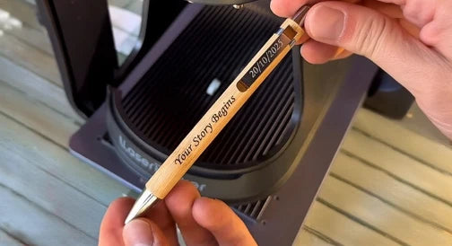 Personalized wooden pen engraved with a motivational quote and date.