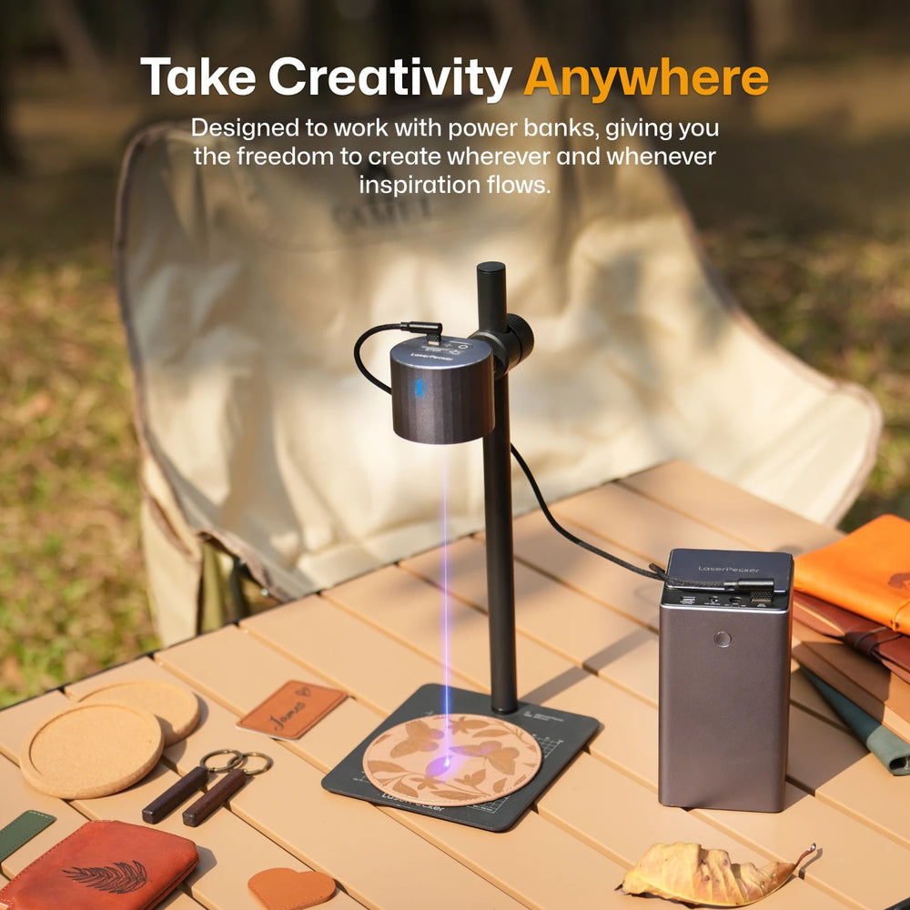 LaserPecker laser engraver powered by portable power bank on wooden surface outdoors ¡ª take creativity anywhere with freedom to create whenever inspiration flows. 