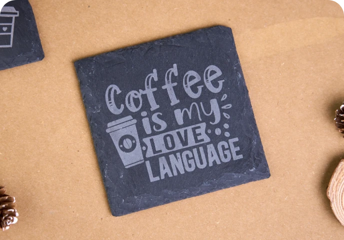 Engraved slate coasters for coffee mugs.